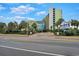 Exterior view of the Coral Beach building with palm trees at 1105 S Ocean Blvd. # 106, Myrtle Beach, SC 29577