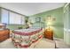 Serene bedroom with floral bedding and a green color scheme at 310 73Rd Ave. N # 5-C, Myrtle Beach, SC 29572