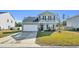 Two-story house with gray siding, white garage door, and landscaping at 438 Archer Ct., Conway, SC 29526