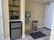 Small kitchen with microwave, mini-fridge, and shelving at 201 74Th Ave. N # 1134, Myrtle Beach, SC 29572