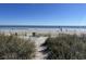 Sandy beach with ocean and distant figures at 201 74Th Ave. N # 1134, Myrtle Beach, SC 29572