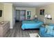 Bedroom with teal bedding, dresser, and ocean view at 201 74Th Ave. N # 1134, Myrtle Beach, SC 29572