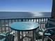 Stunning ocean view from private balcony with table and chairs at 201 74Th Ave. N # 1134, Myrtle Beach, SC 29572