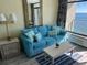 Living area with teal couch and ocean view at 201 74Th Ave. N # 1134, Myrtle Beach, SC 29572