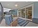 Screened porch with wicker furniture and view of backyard at 7274 Sarteano Dr., Myrtle Beach, SC 29572