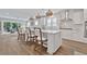 Island kitchen with white cabinets, quartz countertops, and breakfast bar seating at 7274 Sarteano Dr., Myrtle Beach, SC 29572