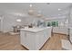 Open concept kitchen with island, white cabinets, and stainless steel appliances at 7274 Sarteano Dr., Myrtle Beach, SC 29572