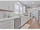 Bright kitchen boasts white cabinets, quartz countertops, and stainless steel dishwasher at 7274 Sarteano Dr., Myrtle Beach, SC 29572