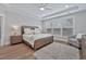 Bright bedroom with wood floors, a ceiling fan, and large windows at 7274 Sarteano Dr., Myrtle Beach, SC 29572
