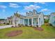 Light blue house exterior with a front porch and landscaping at 7274 Sarteano Dr., Myrtle Beach, SC 29572