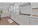 Modern kitchen features white cabinets, quartz countertops, and stainless steel appliances at 7274 Sarteano Dr., Myrtle Beach, SC 29572