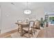 Light and airy dining room with wood table and four chairs at 7274 Sarteano Dr., Myrtle Beach, SC 29572