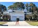 Brick front townhouse with two-car garage and landscaping at 493 Shellbank Dr. # 2-B, Longs, SC 29568