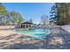 Inviting community pool with a paver patio and shaded seating area at 493 Shellbank Dr. # 2-B, Longs, SC 29568