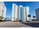 Exterior view of a high-rise condominium building with parking in front at 2511 S Ocean Blvd. # 1107, Myrtle Beach, SC 29577