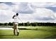 Golfer taking a swing on a lush green golf course at 423 Ribbon Rail Way, Loris, SC 29569