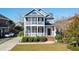 Two-story home with a wrap-around porch and manicured lawn at 879 Waterton Ave., Myrtle Beach, SC 29579