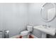 Small bathroom with pedestal sink, toilet and oval mirror at 879 Waterton Ave., Myrtle Beach, SC 29579
