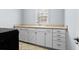 Laundry room with white cabinets, a utility sink, and vinyl flooring at 879 Waterton Ave., Myrtle Beach, SC 29579