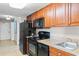 Condo kitchen with dark wood cabinets and black appliances at 5200 N Ocean Blvd. # 1231, Myrtle Beach, SC 29577
