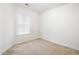 Empty bedroom with neutral walls and carpet, featuring a window at 111 Portsmith Dr. # 6, Myrtle Beach, SC 29588