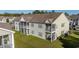 Rear view of a tan building with multiple units, balconies, and screened porches at 111 Portsmith Dr. # 6, Myrtle Beach, SC 29588