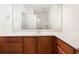 Clean bathroom with wood cabinets and a large vanity mirror at 111 Portsmith Dr. # 6, Myrtle Beach, SC 29588