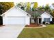 White one-story house with two-car garage and landscaped yard at 172 Collins Glen Dr., Murrells Inlet, SC 29576