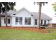 White house exterior with large windows and hot tub at 172 Collins Glen Dr., Murrells Inlet, SC 29576
