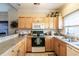 Well-equipped kitchen with light wood cabinets and appliances at 4880 Dahlia Ct. # 305, Myrtle Beach, SC 29577