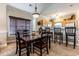Bright dining area with table and chairs,window, and view to kitchen at 4880 Dahlia Ct. # 305, Myrtle Beach, SC 29577