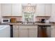 Kitchen with white cabinets, granite counters, and a double sink at 114 N Pinewood Dr. N, Surfside Beach, SC 29575
