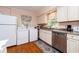 Kitchen with white cabinets, stainless steel appliances, and laundry at 114 N Pinewood Dr. N, Surfside Beach, SC 29575