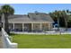 Community pool with lounge chairs and a clubhouse at 4893 Magnolia Pointe Ln. # 103, Myrtle Beach, SC 29577