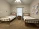Cozy bedroom with twin beds, neutral decor, and ample natural light at 4893 Magnolia Pointe Ln. # 103, Myrtle Beach, SC 29577