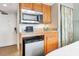 Small kitchenette with microwave, fridge, and sink at 2700 N Ocean Blvd. # 1554, Myrtle Beach, SC 29577