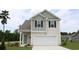 Two-story house with gray and beige siding and a two-car garage at 651 Wallace Dr., Little River, SC 29566