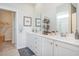 Double vanity bathroom with white cabinets and a walk-in shower at 651 Wallace Dr., Little River, SC 29566