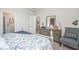 Main bedroom with dresser, sitting chair, and access to the bathroom and dining room at 651 Wallace Dr., Little River, SC 29566