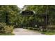 Entrance to Vereen Memorial Historical Gardens, featuring a wrought-iron arch and lush landscaping at 651 Wallace Dr., Little River, SC 29566