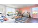 Bright living room with coral accent wall and comfy seating at 510 Firouz Dr, Longs, SC 29568