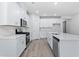 Modern kitchen with white cabinets, quartz countertops, and stainless steel appliances at 7032 Watercress St, Myrtle Beach, SC 29579