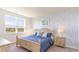 Bedroom with blue bedding, patterned wall, and natural light at 7302 Meadow Walk Loop, Loris, SC 29569