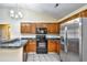 Kitchen with wood cabinets, granite countertops, and stainless steel appliances at 4336 Summitt Trail, Myrtle Beach, SC 29579