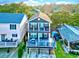 Two-story home with gray siding, deck, and surrounding houses at 6001 - 1191 S Kings Hwy., Myrtle Beach, SC 29575