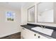 Bathroom with single vanity, dark countertop, window, and wood-look flooring at 128 Forman Way, Aynor, SC 29511