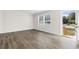 Empty living room with wood-look laminate flooring and white walls at 128 Forman Way, Aynor, SC 29511