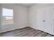 Simple bedroom with wood-look floors and double door closet at 219 Sundrop Way, Conway, SC 29526