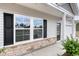 House exterior showcasing a front door, stone accents, and shutters at 219 Sundrop Way, Conway, SC 29526