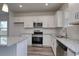 Modern kitchen with stainless steel appliances and white cabinets at 219 Sundrop Way, Conway, SC 29526